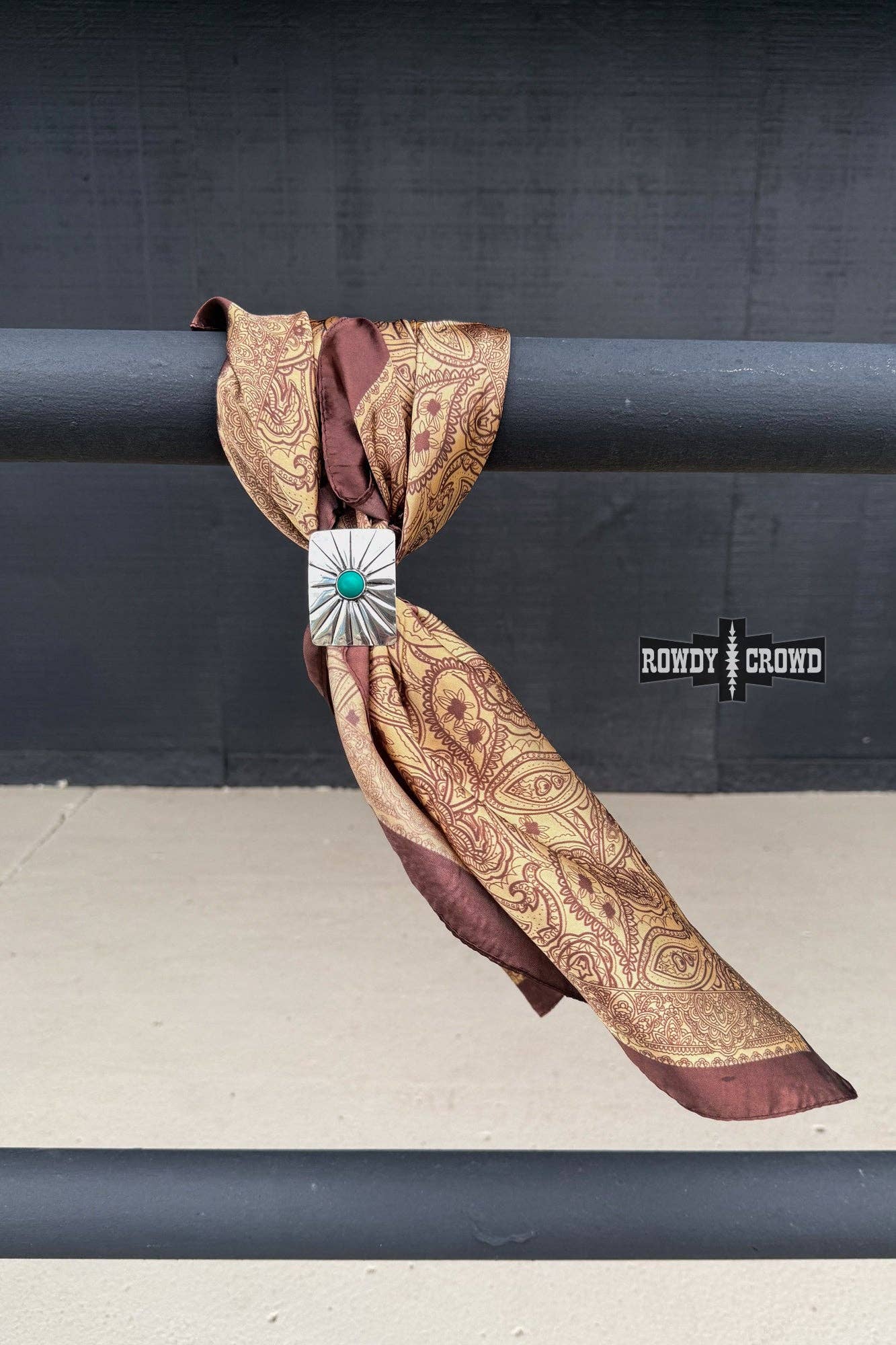 Decorative scarf with a brooch on a black background