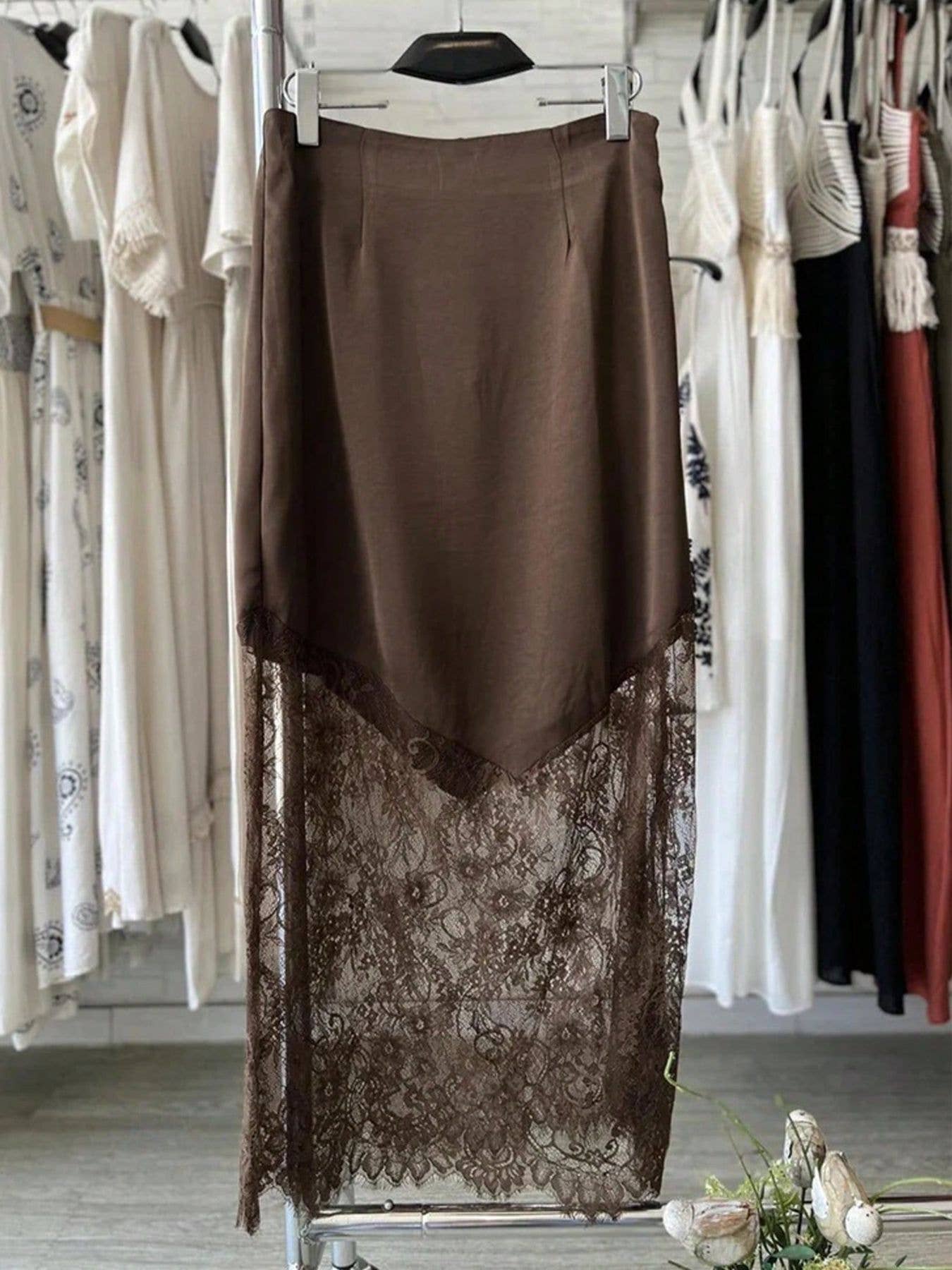 Brown skirt with lace detailing on a rack in a clothing store