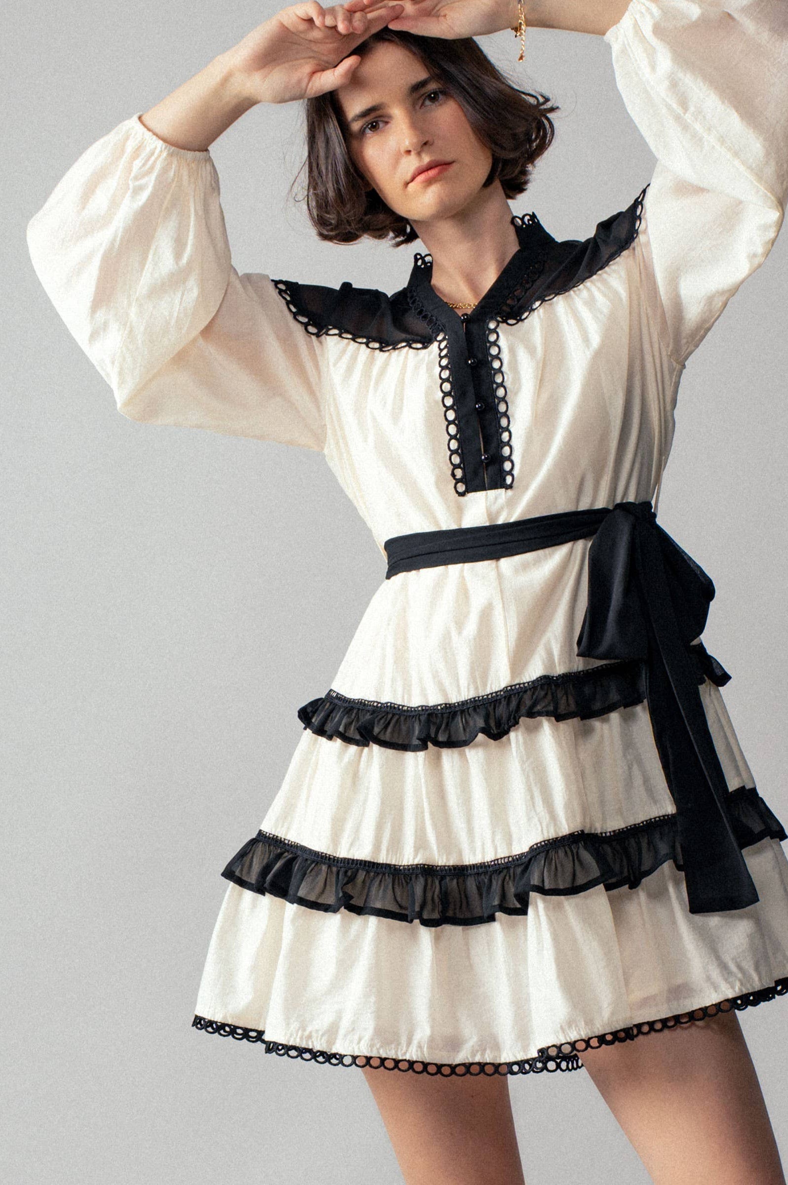 White dress with black accents on a gray background