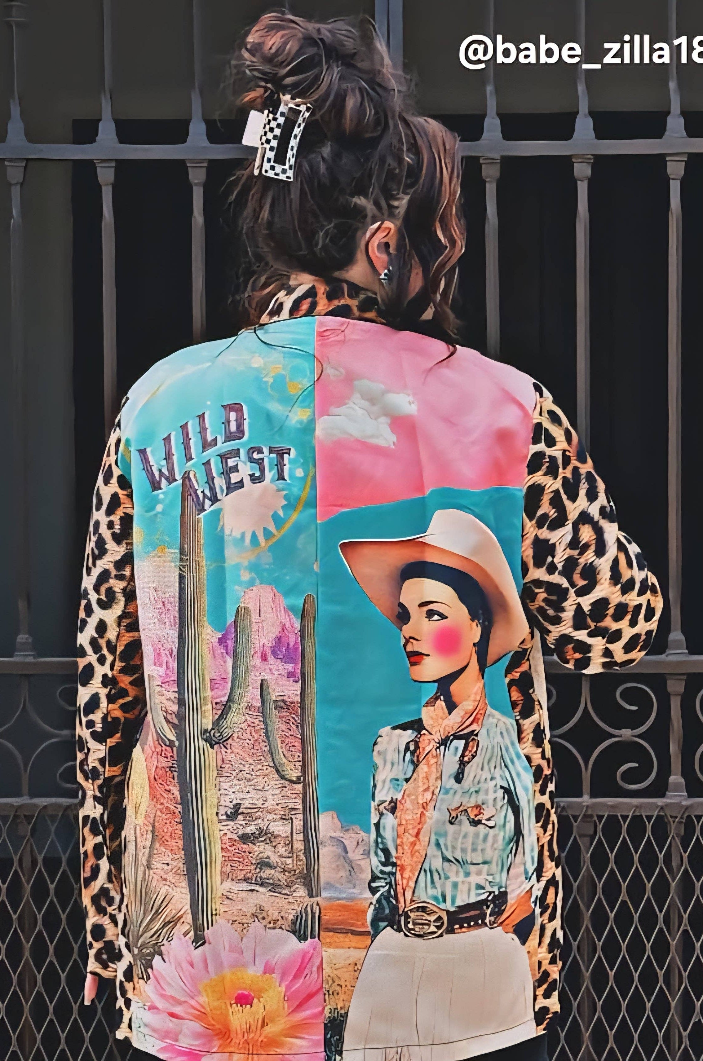 Person wearing a colorful jacket with artistic designs and text.