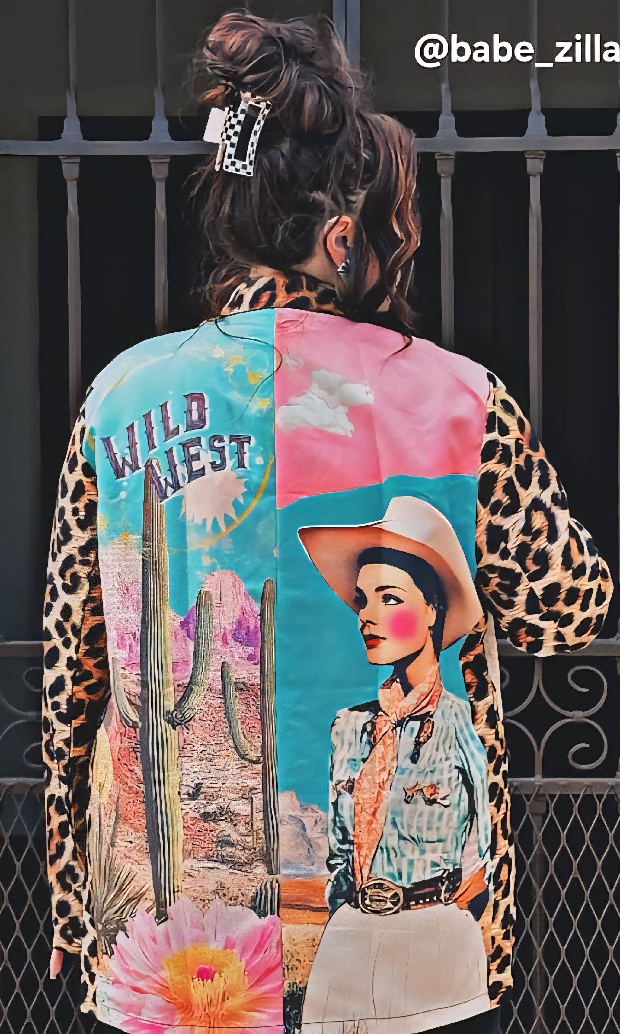 Person wearing a colorful jacket with artistic designs and text.