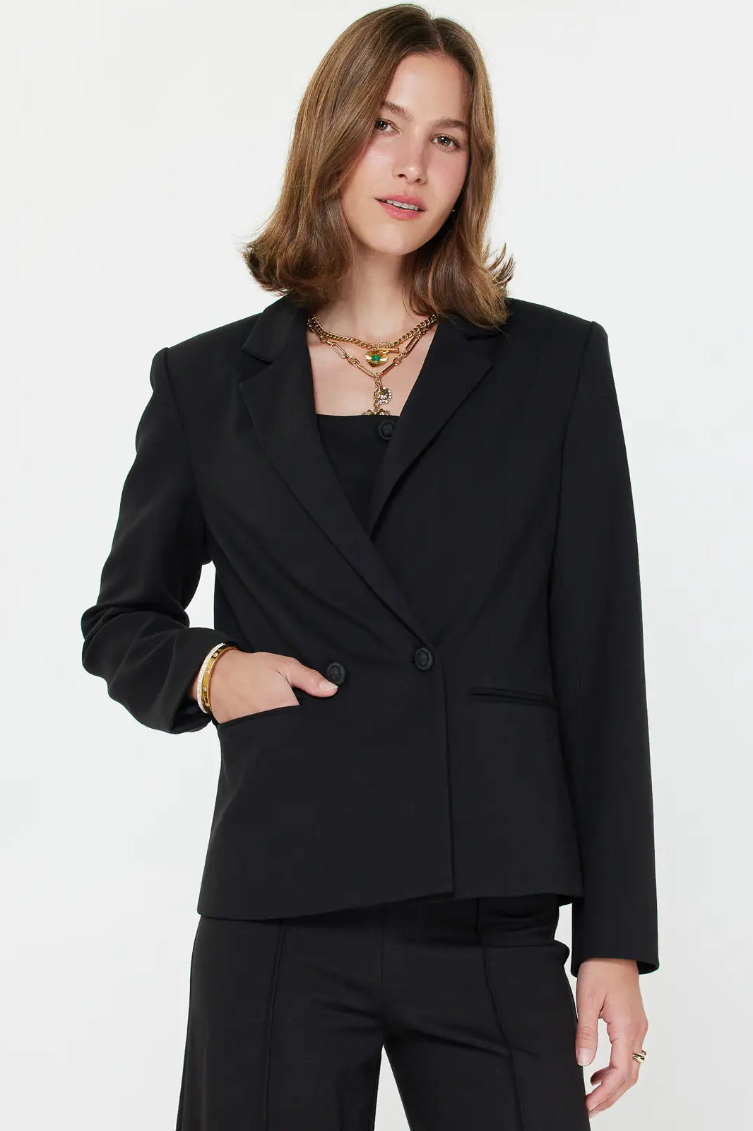 Woman wearing a black blazer on a white background