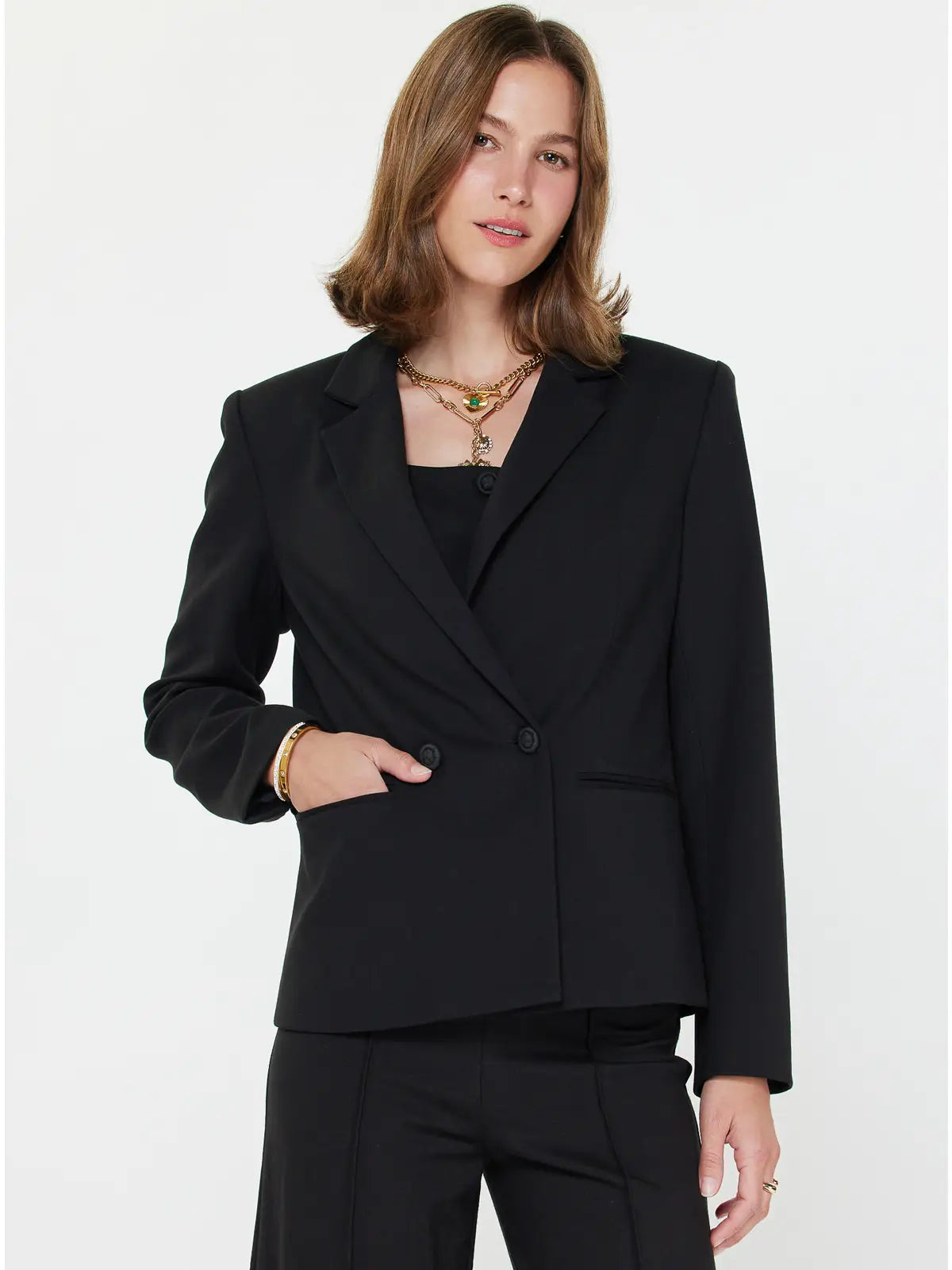 Woman wearing a black blazer on a white background