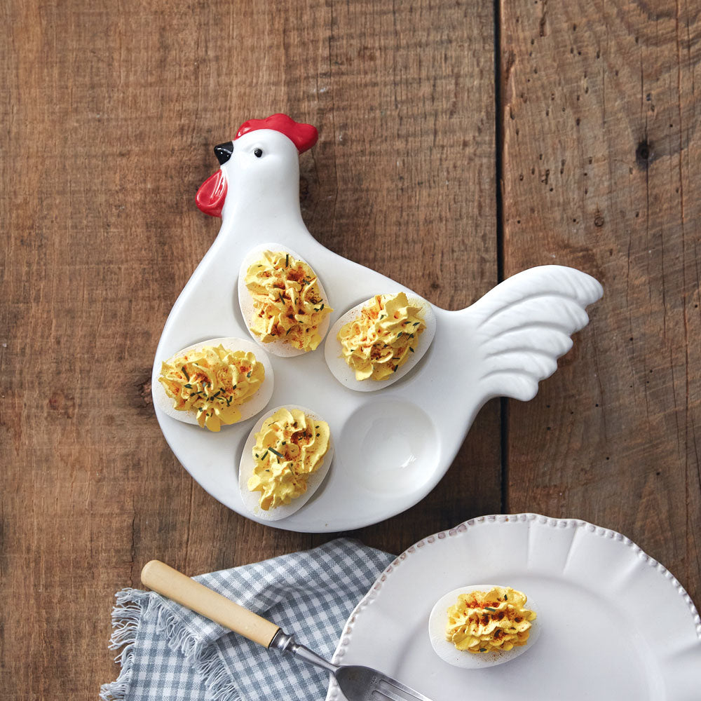 Chicken-shaped plate with deviled eggs on a wooden surface