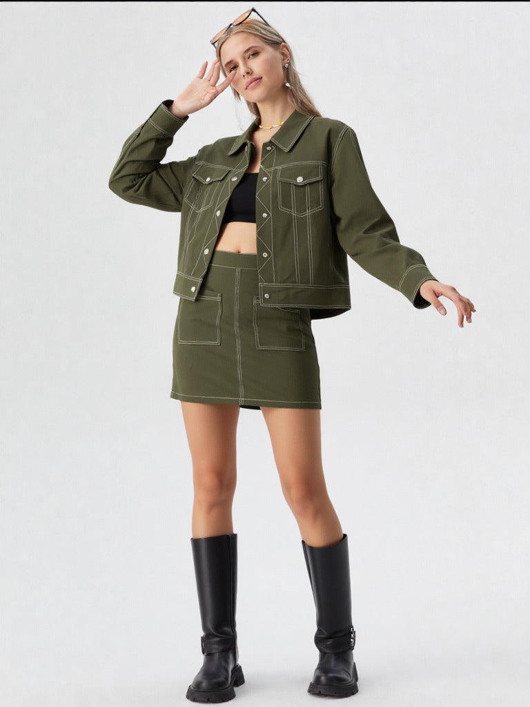 Woman wearing a green jacket and skirt set with black boots on a white background