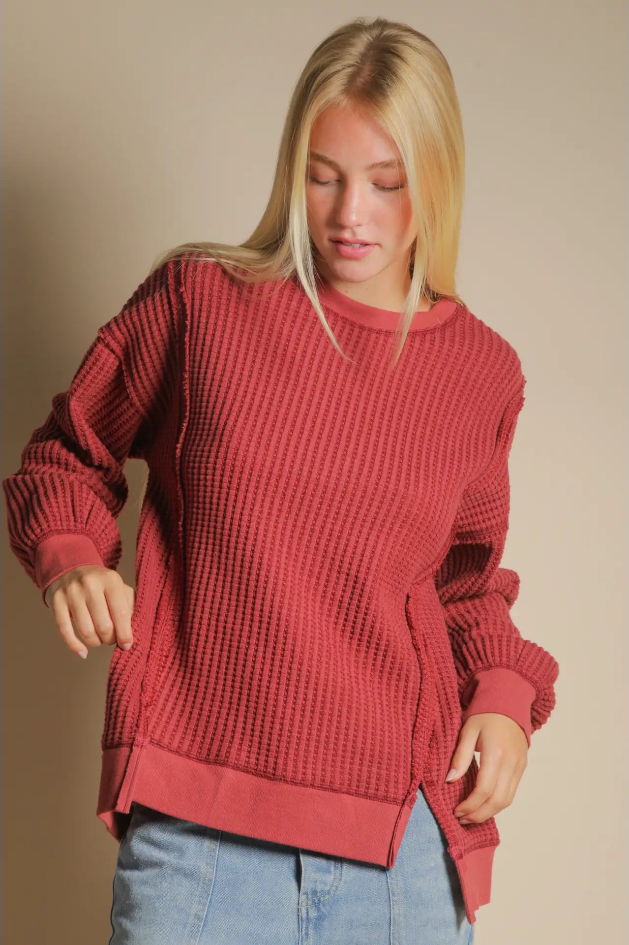Front view of burgundy oversized waffle knit top with round neck and drop shoulders.