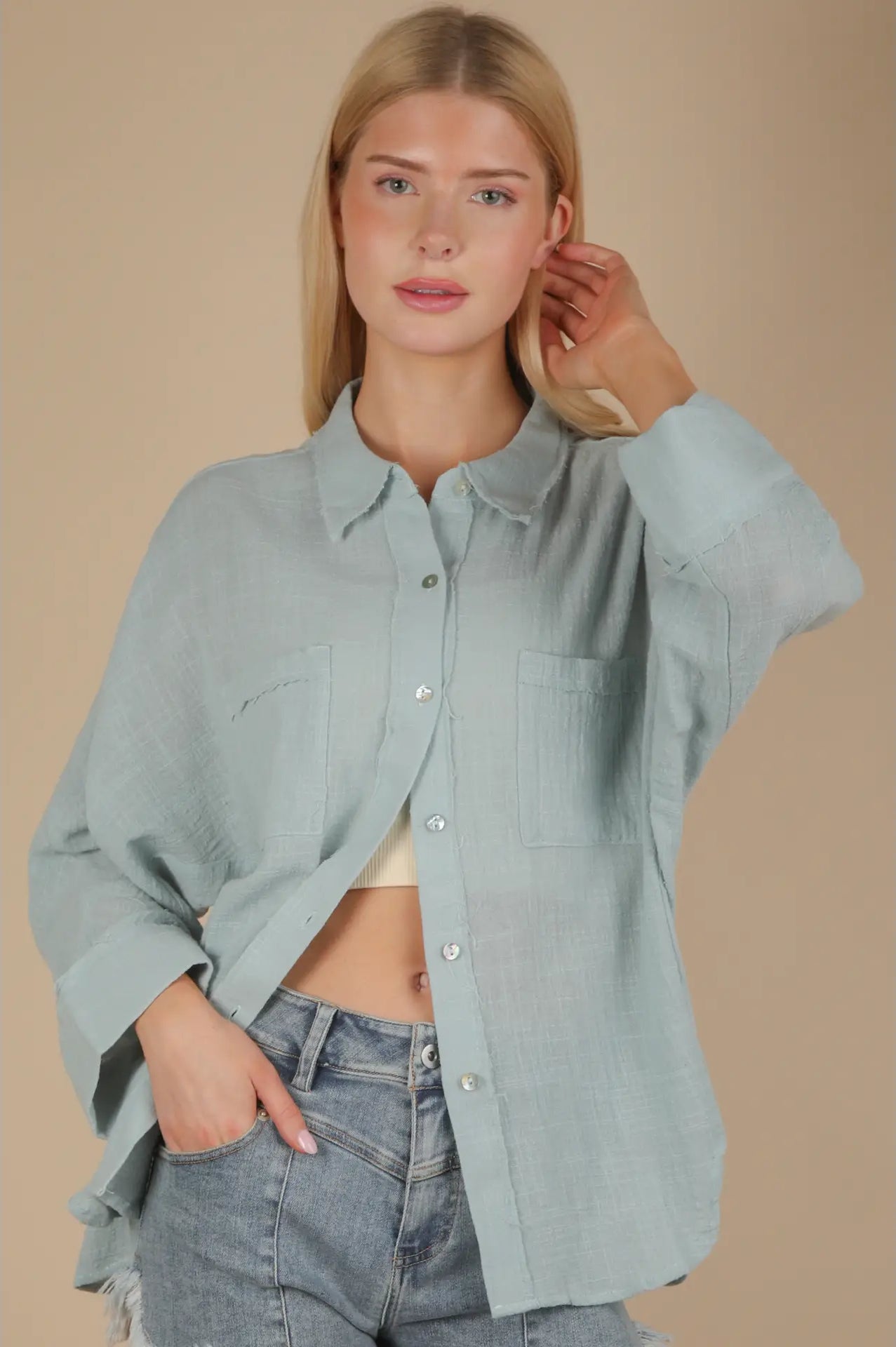 Front view of sky blue dolman-sleeve gauze button-down with patch pockets