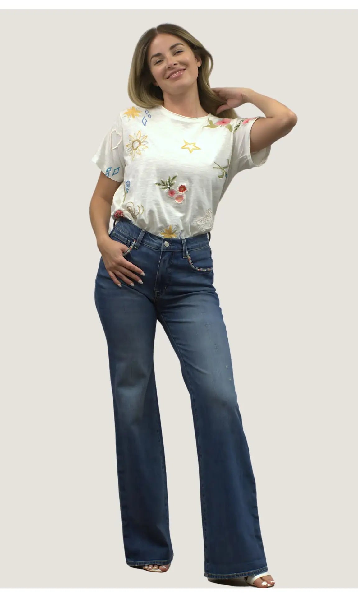 Woman wearing blue jeans with embroidery on the pocket edges