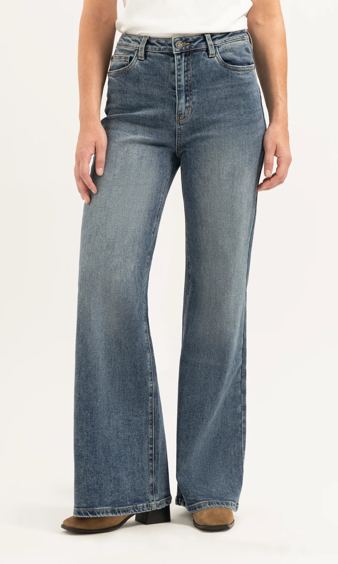 Person wearing blue jeans on a white background