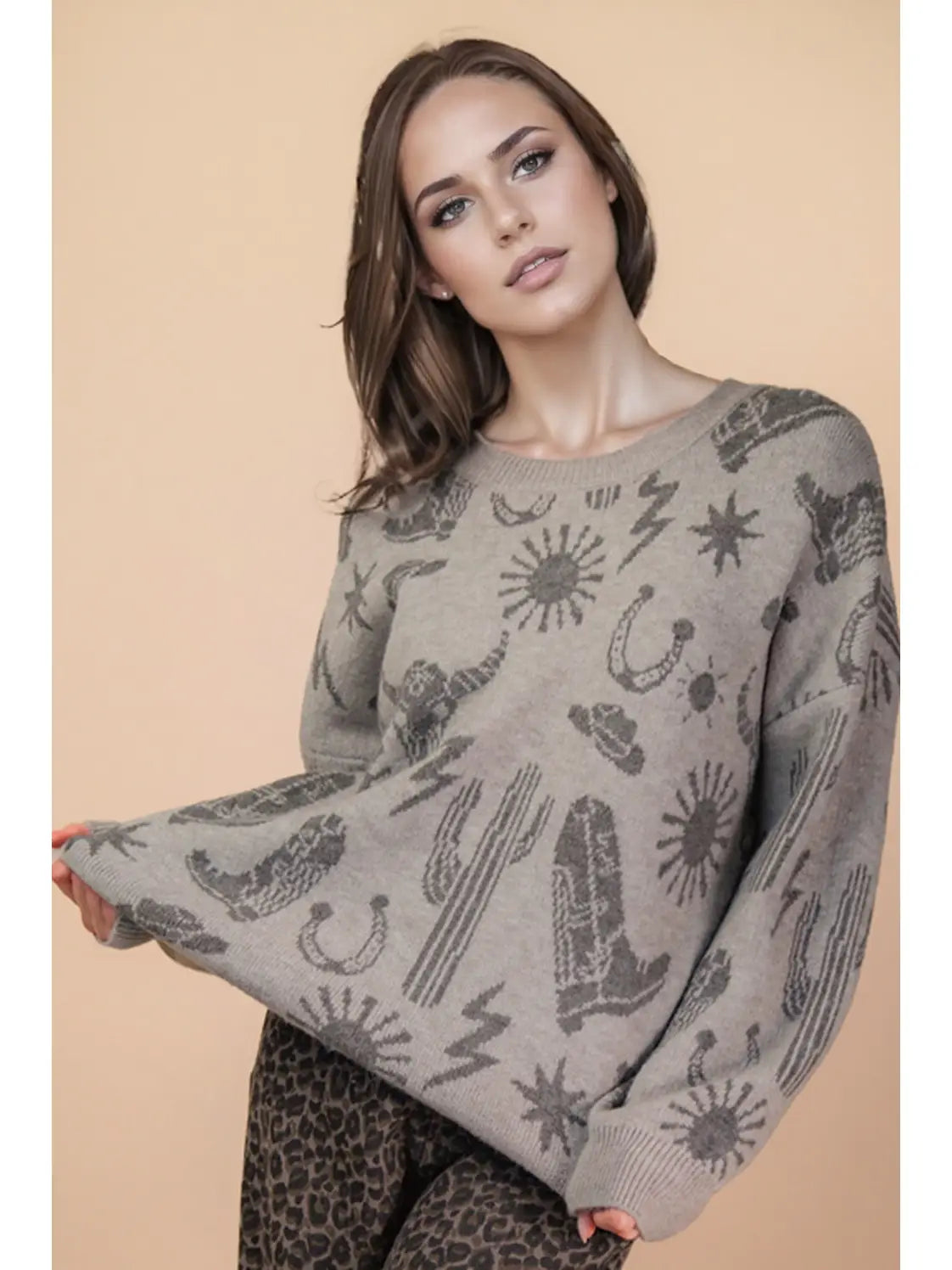 Front view of grey oversized knit sweater with western graphic, round neck, and drop shoulders