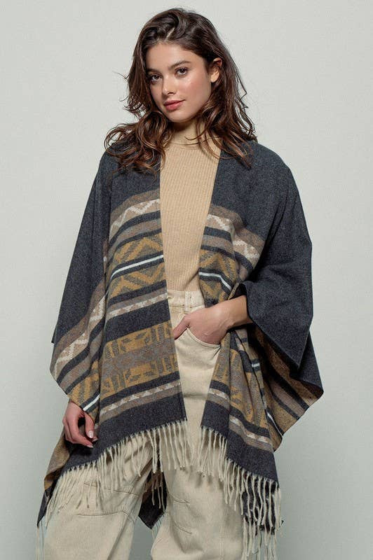 Dark gray poncho with brown and beige striped pattern and fringes on a white background
