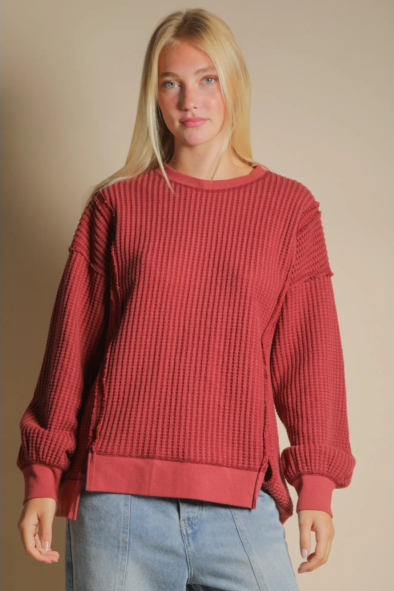 Front view of burgundy oversized waffle knit top with round neck and drop shoulders.