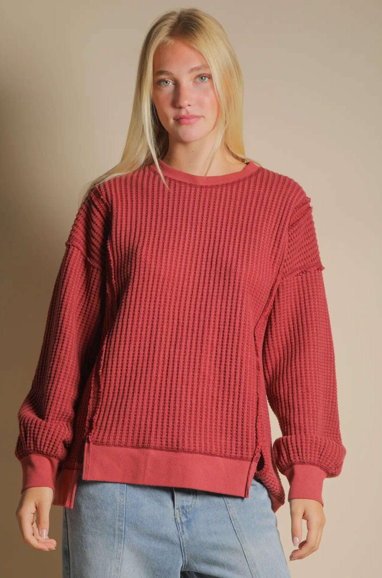 Front view of burgundy oversized waffle knit top with round neck and drop shoulders.