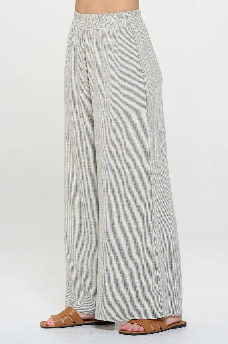 Light gray pin stripped pants worn with elastic waist by a person