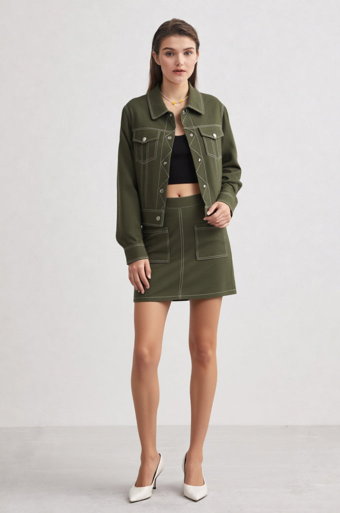 Woman wearing a green jacket and skirt on a white background