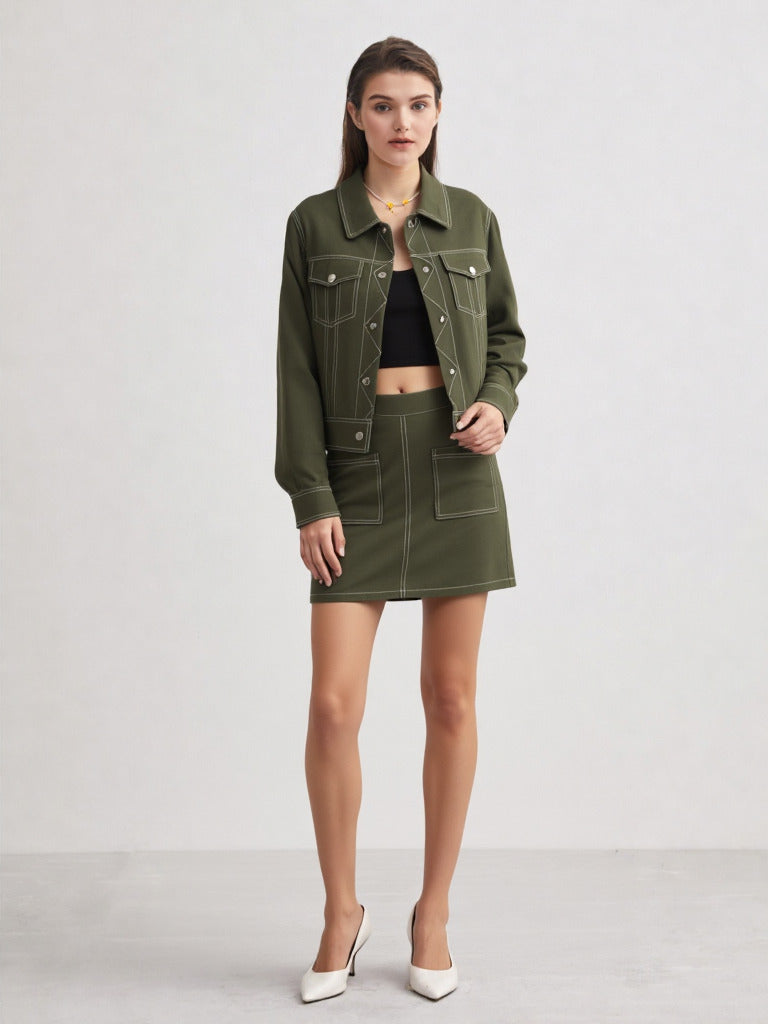 Woman wearing a green jacket and skirt on a white background