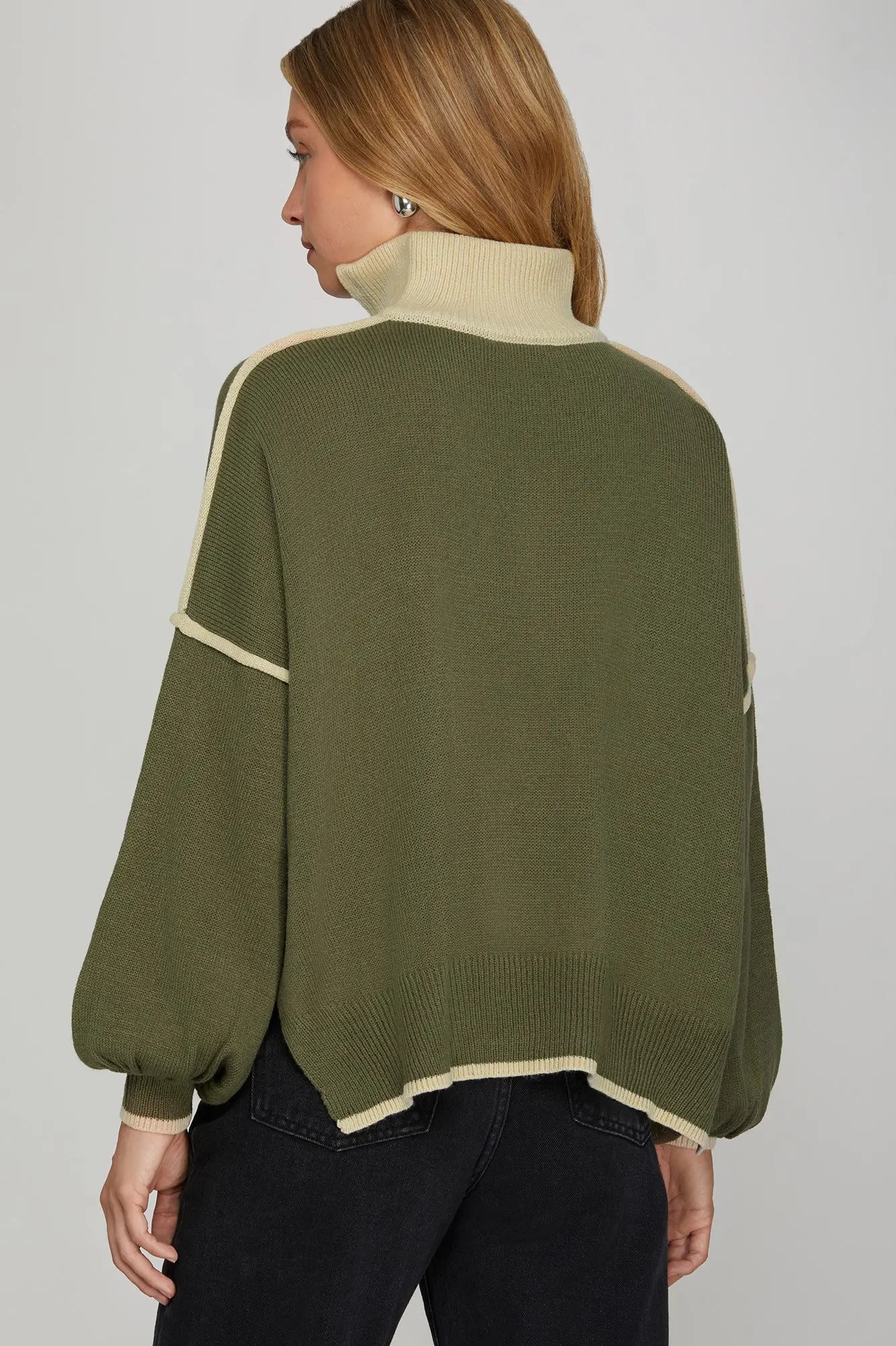 Back of sweater view Person wearing a green sweater with white trim and collar