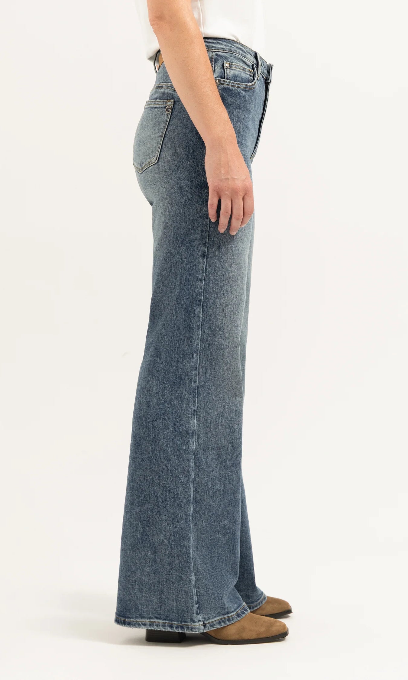 Person wearing blue jeans on a white background