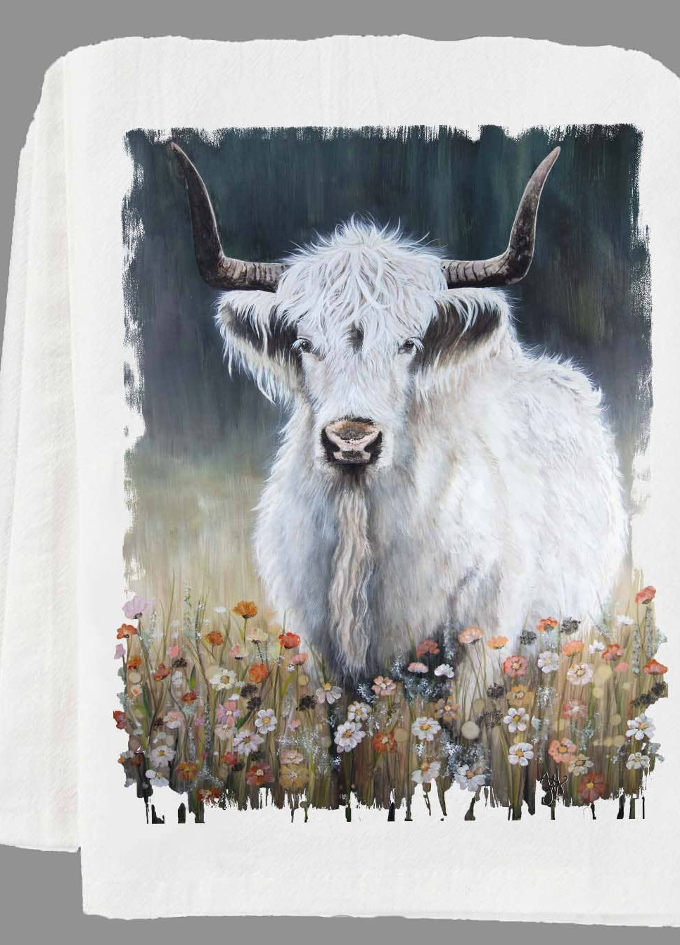 Folded kitchen towel with a highland cow design on a gray background