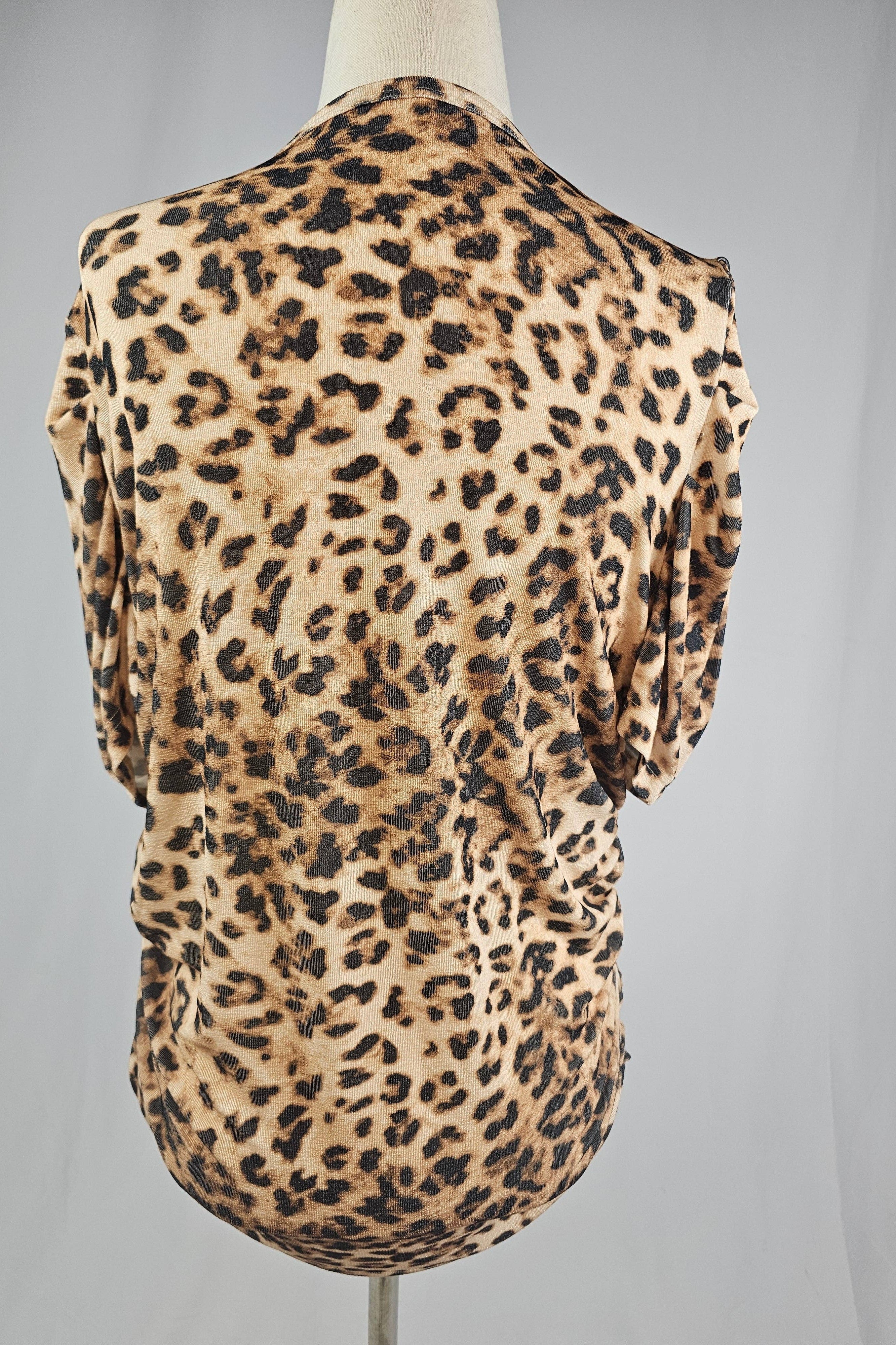 Leopard print sleeveless top on a mannequin against a gray background