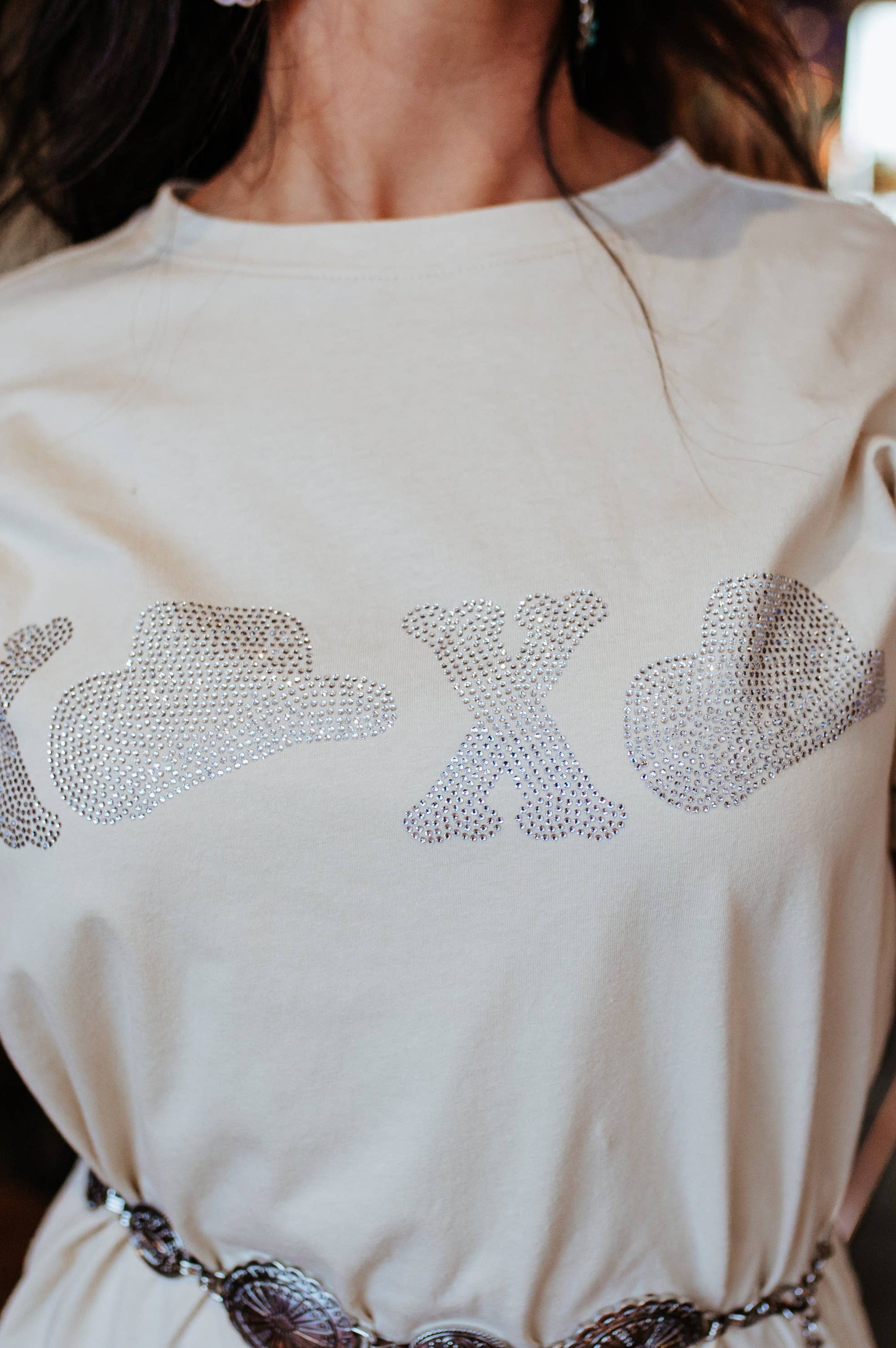 Woman wearing a white dress with decorative elements, indoors.