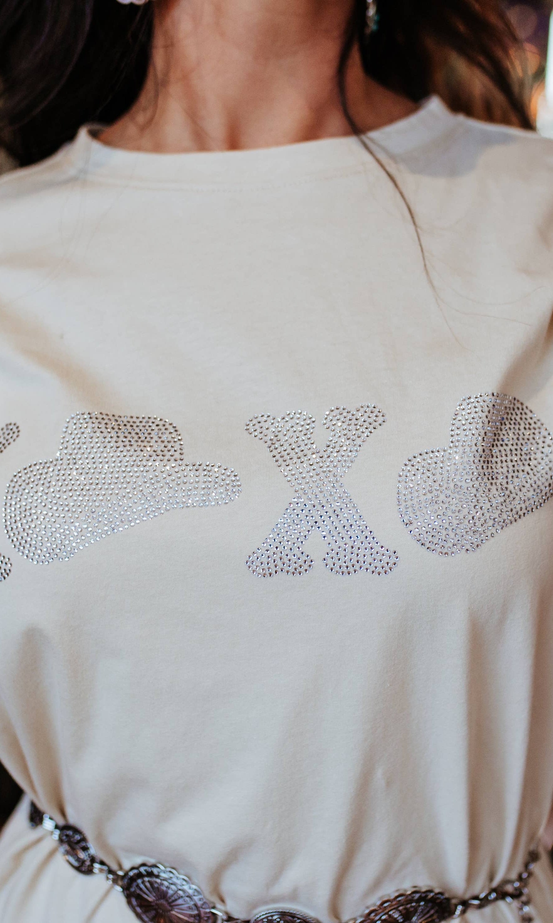 Woman wearing a white dress with decorative elements, indoors.