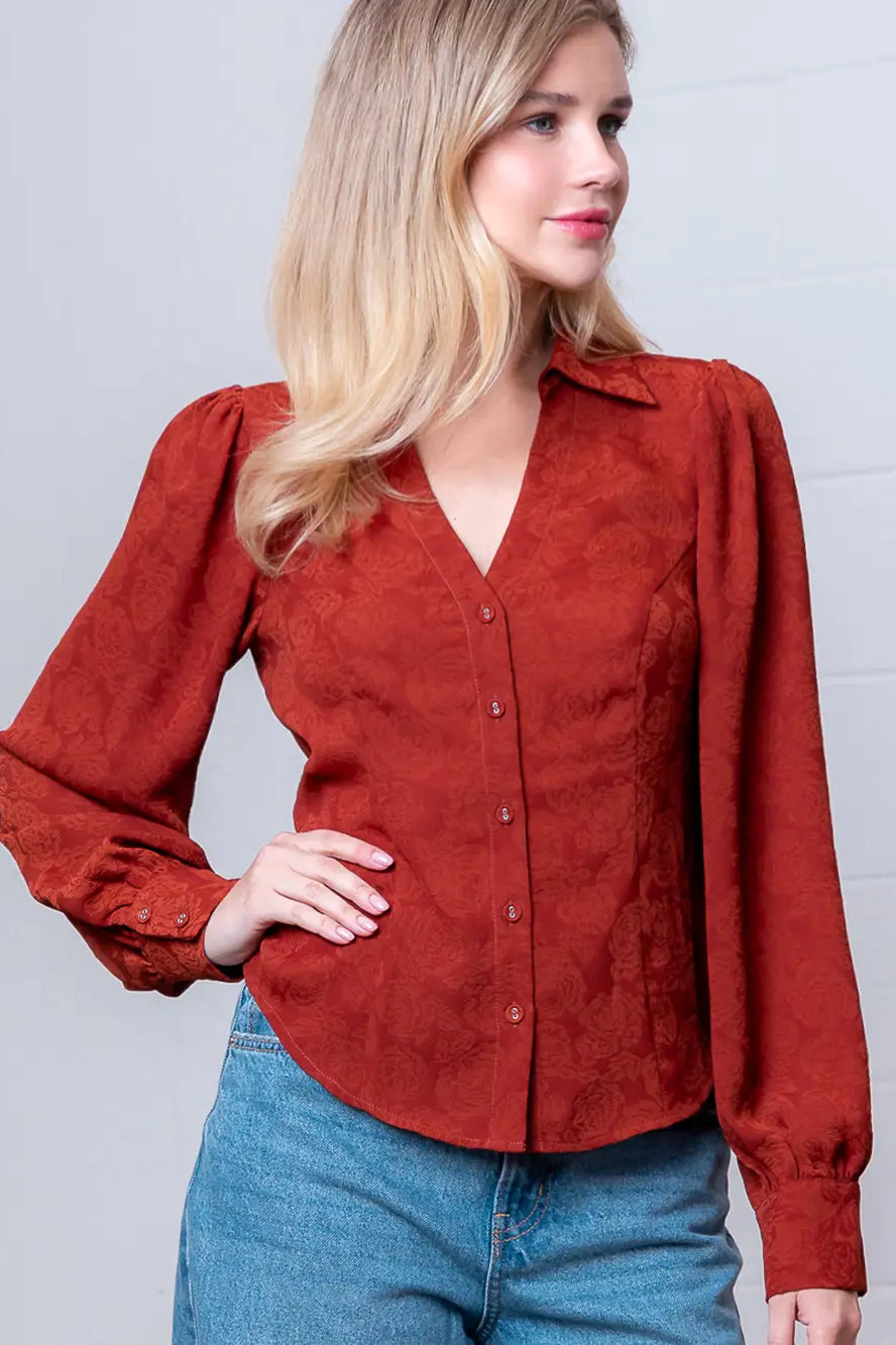 Front view of rust Western-inspired embossed blouse showing tailored waist and button front.