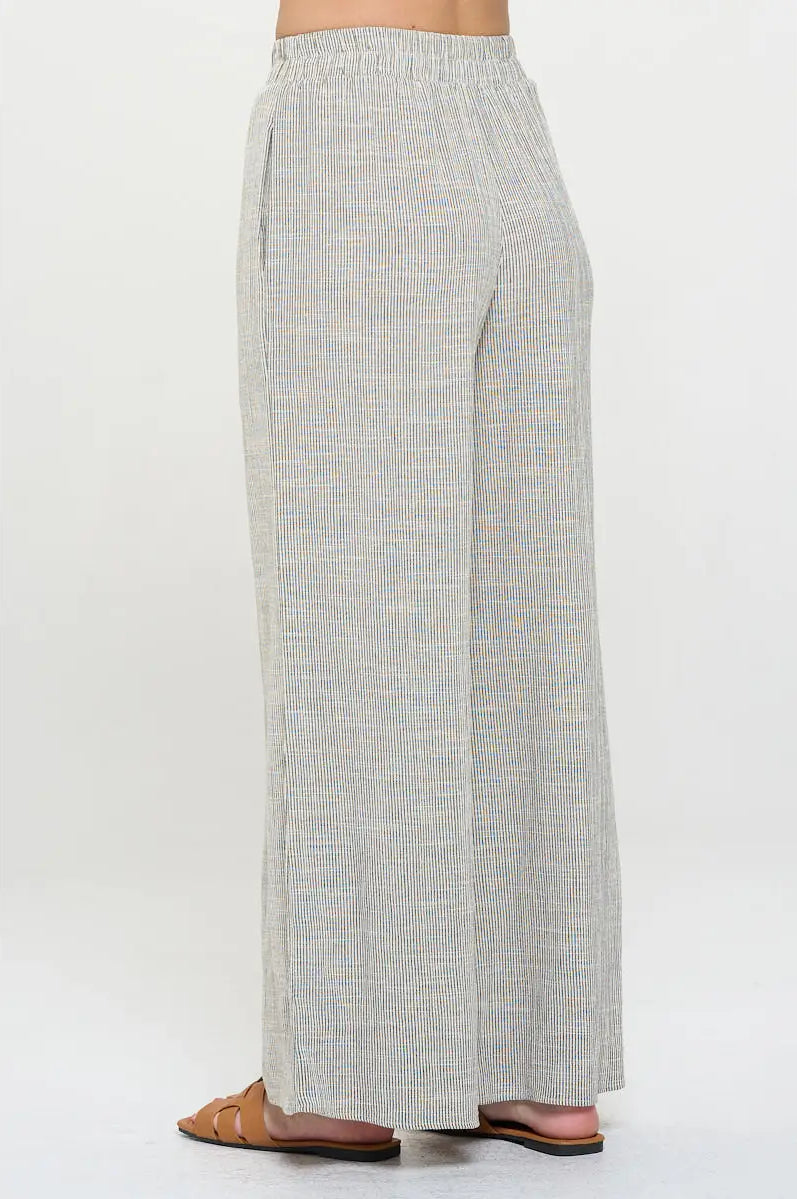 Light gray pin stripped pants worn with elastic waist by a person