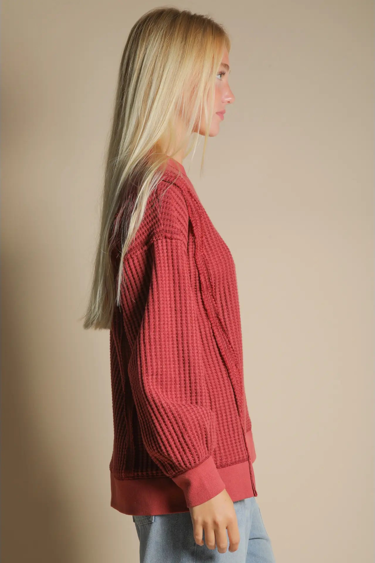Side angle showing front slit and relaxed drape of waffle knit pullover