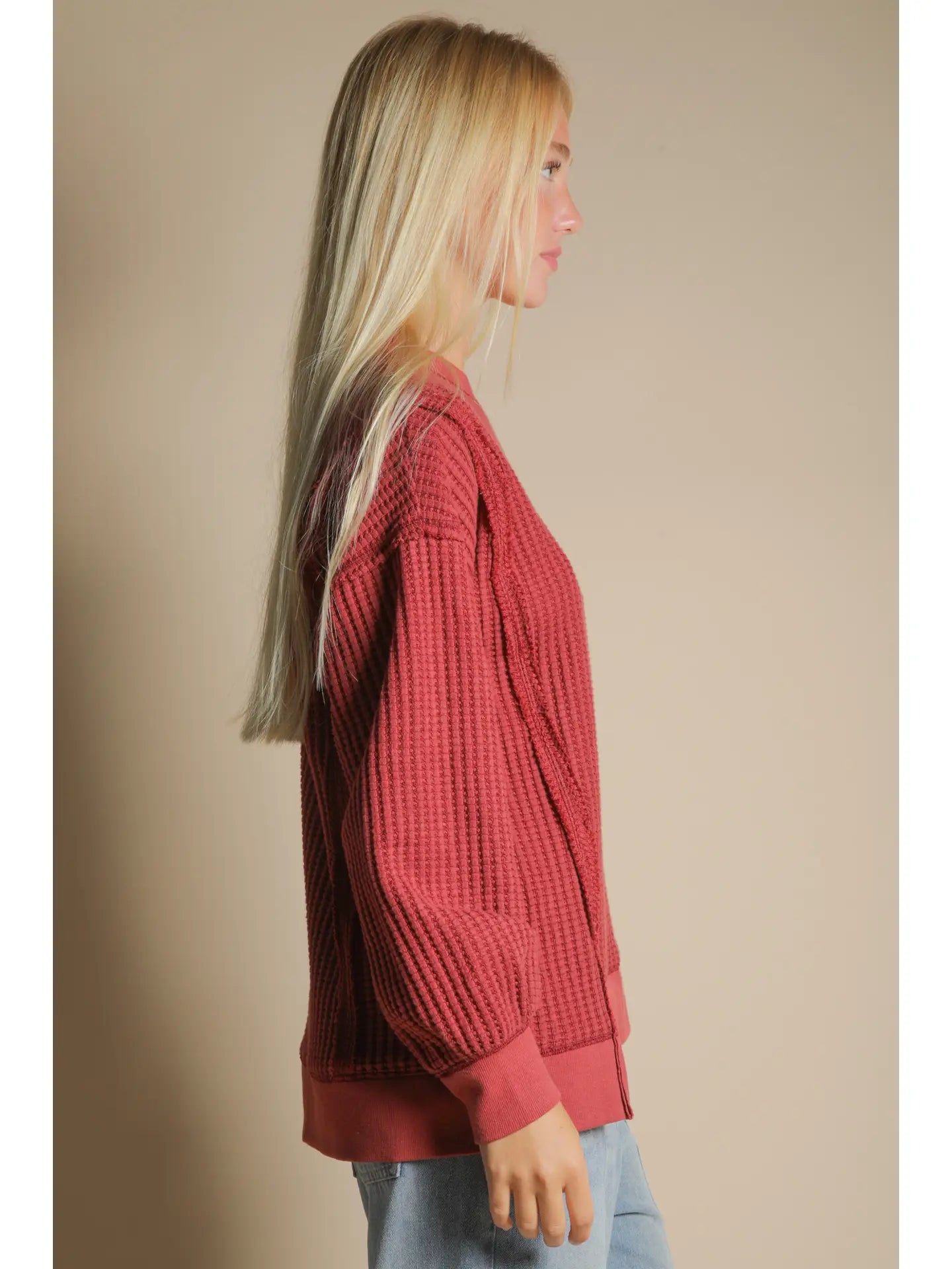 Side angle showing front slit and relaxed drape of waffle knit pullover