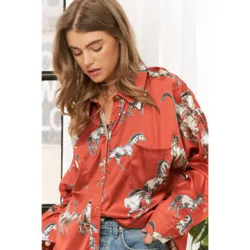 Woman wearing a rust shirt with horse print