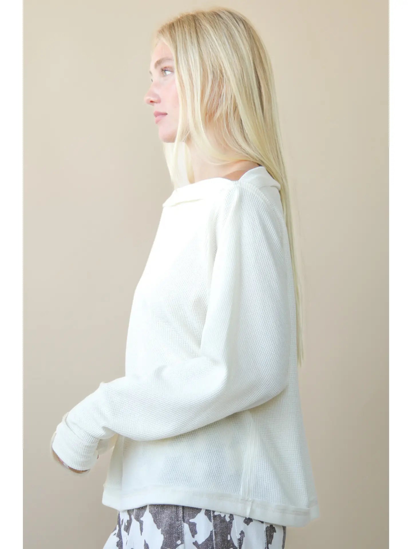 Side angle showing relaxed fit and hip-length of boat-neck top