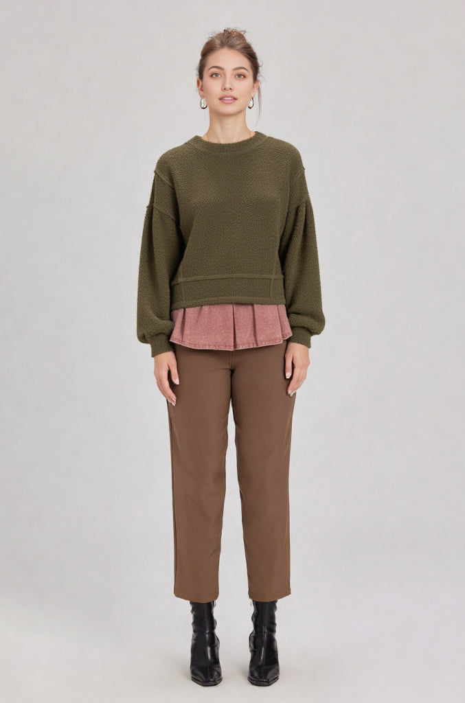 Woman in a olive round-neck textured knit oversized top with drop shoulders and long sleeves, relaxed fit.