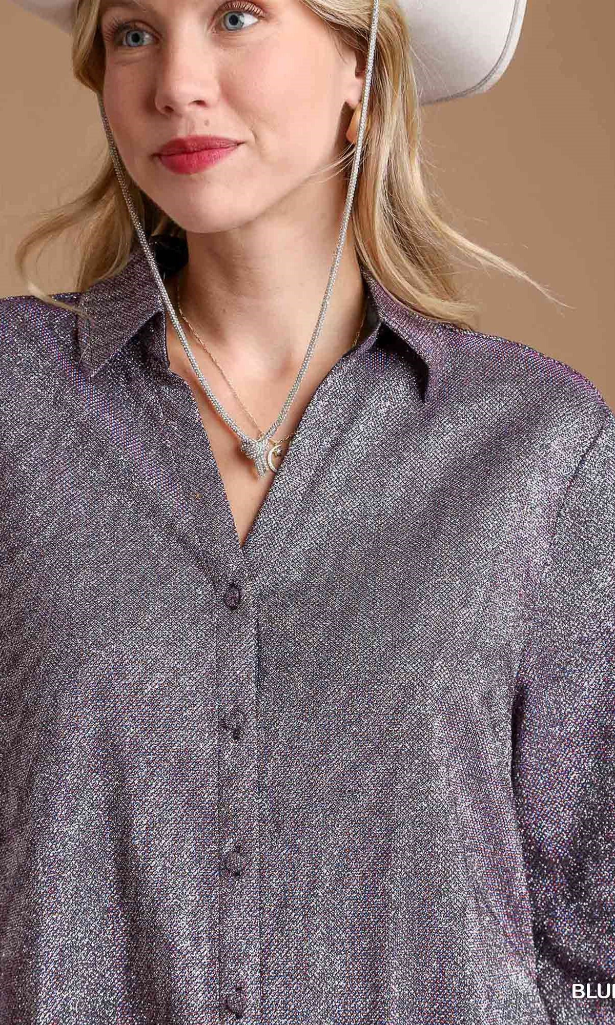 Woman wearing a gray button-up shirt and white cowboy hat against a beige background