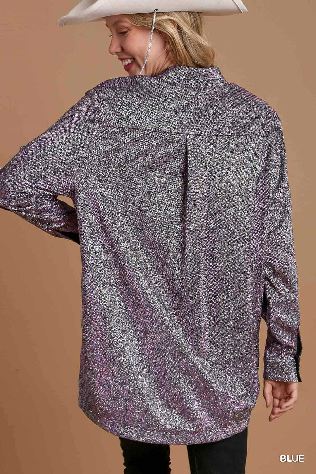 Person wearing a sparkly silver jacket on a brown background