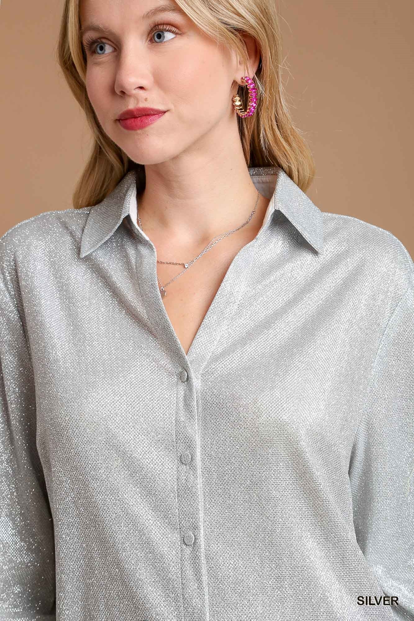 Woman wearing a silver shirt with a neutral background