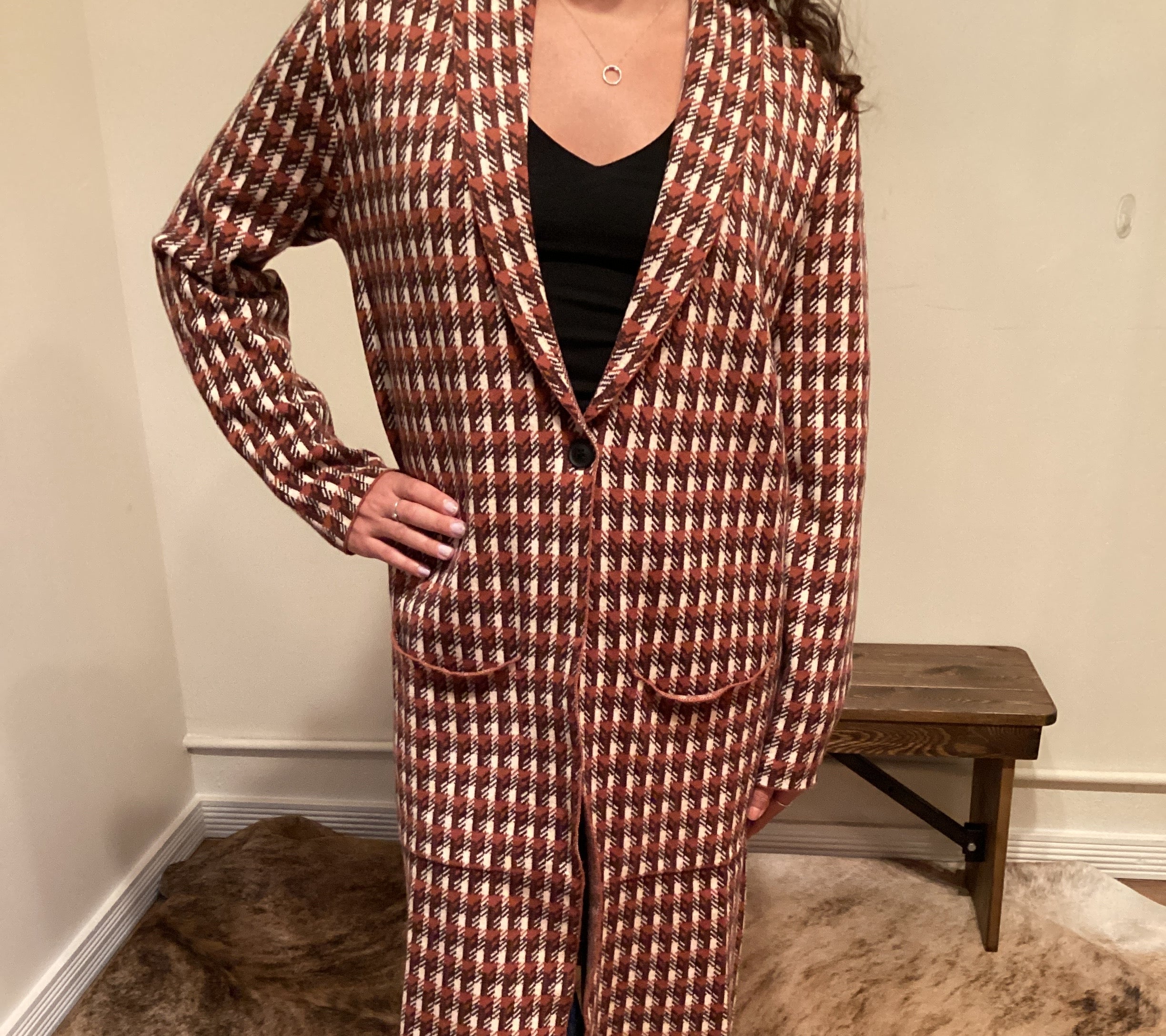 Rust and brown check pattern long cardigan with a single button and pockets hits mid shin