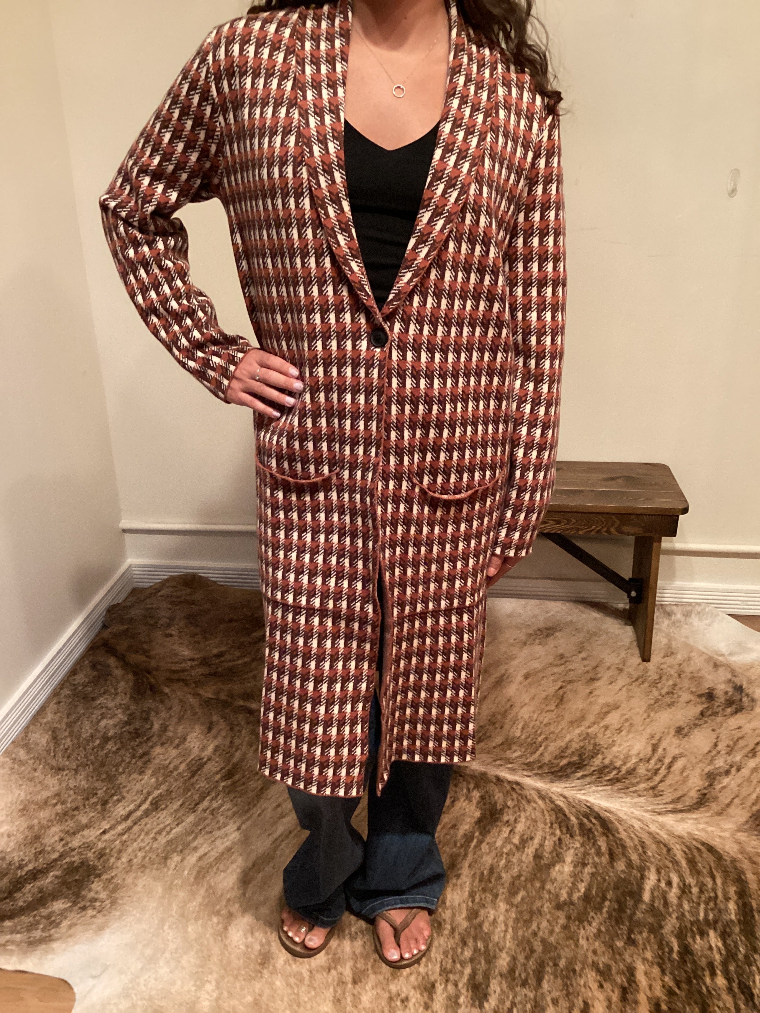 Rust and brown check pattern long cardigan with a single button and pockets hits mid shin