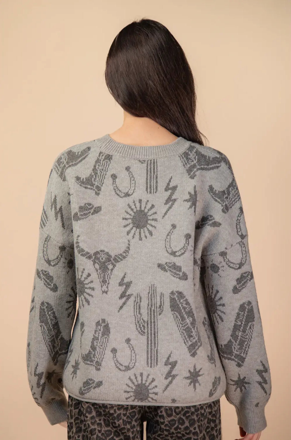 Back view of grey oversized knit sweater with rib hem and cuffs