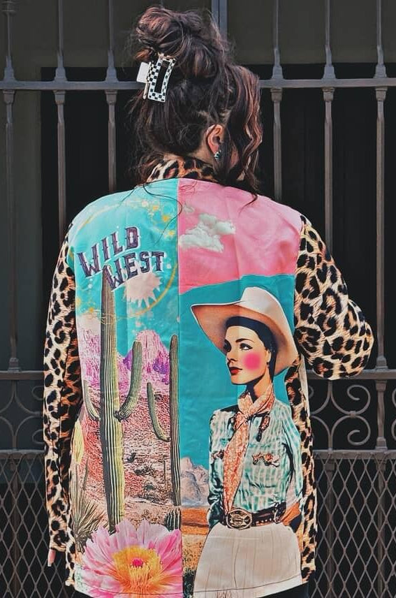 Colorful patchwork jacket with a cowboy design and 'Wild West' text, worn by a person.