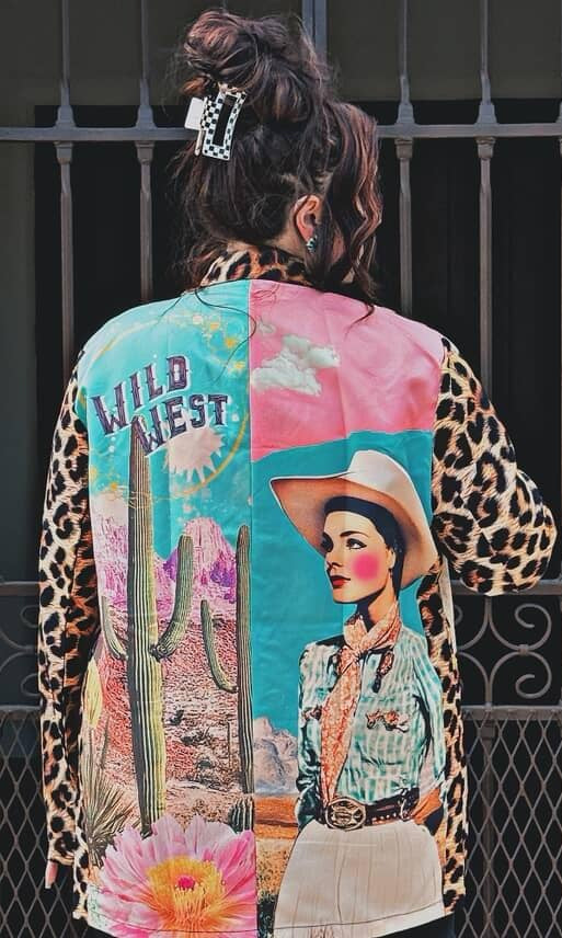 Colorful patchwork jacket with a cowboy design and 'Wild West' text, worn by a person.