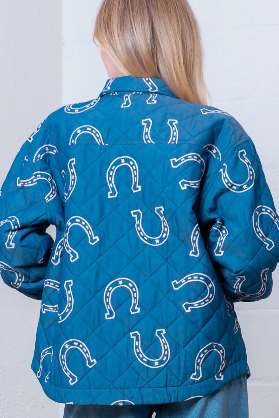 Back view highlighting overall horseshoe pattern on blue quilted coat.