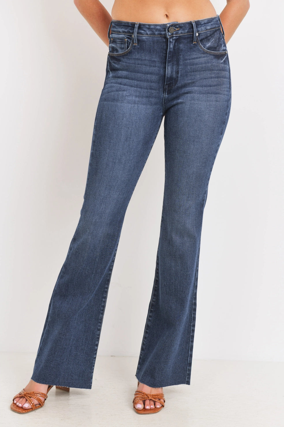 Blue jeans worn by a person on a white background