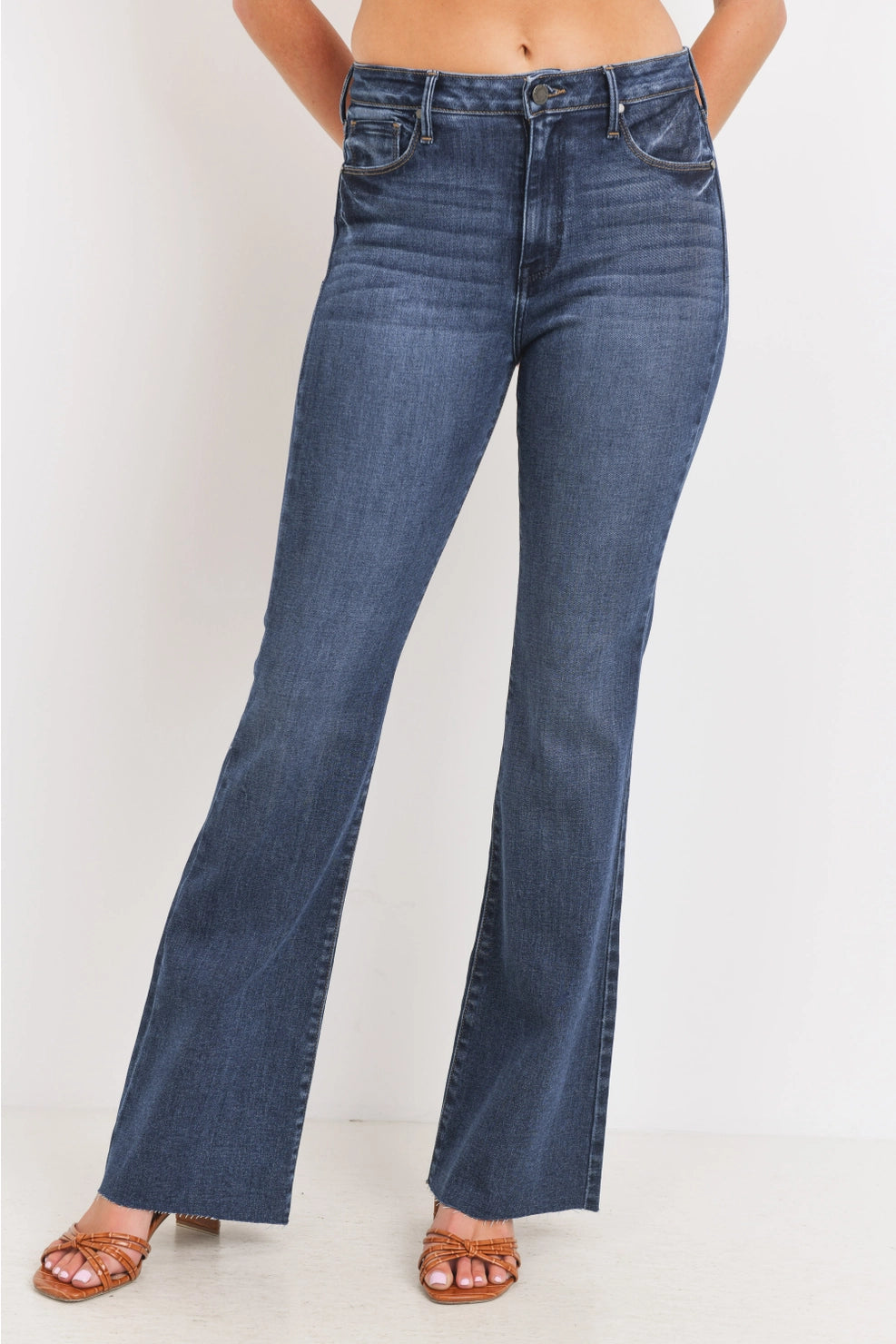 Blue jeans worn by a person on a white background