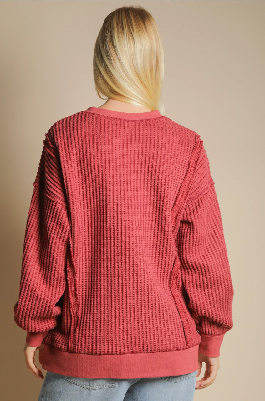 Back view of oversized waffle top with long sleeves and curved hem