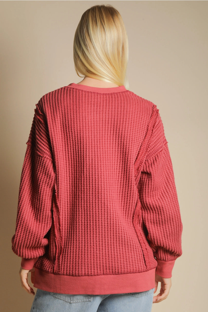 Back view of oversized waffle top with long sleeves and curved hem