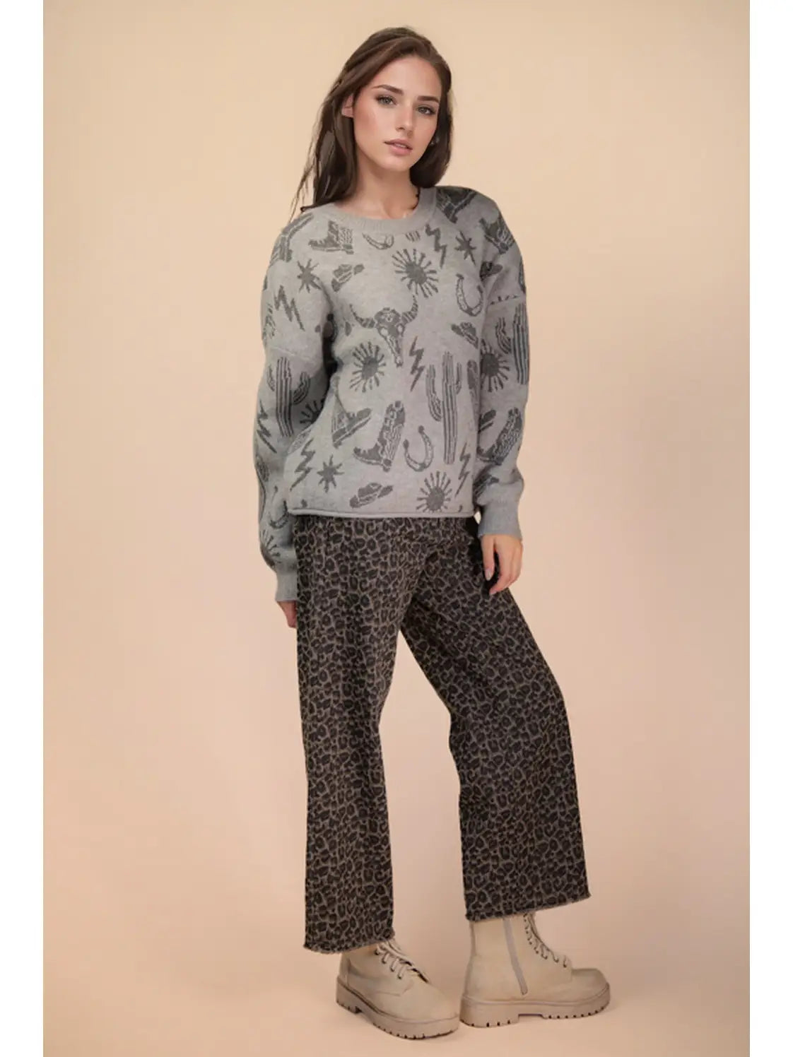 Front view of grey oversized knit sweater with western graphic, round neck, and drop shoulders