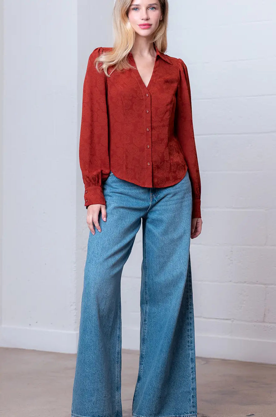 Front view of rust Western-inspired embossed blouse showing tailored waist and button front.