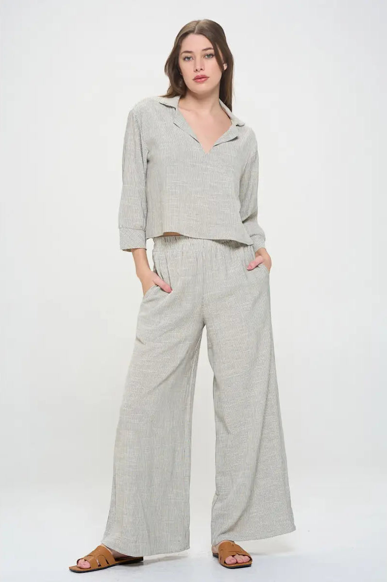 Light gray pin stripped pants worn with elastic waist by a person