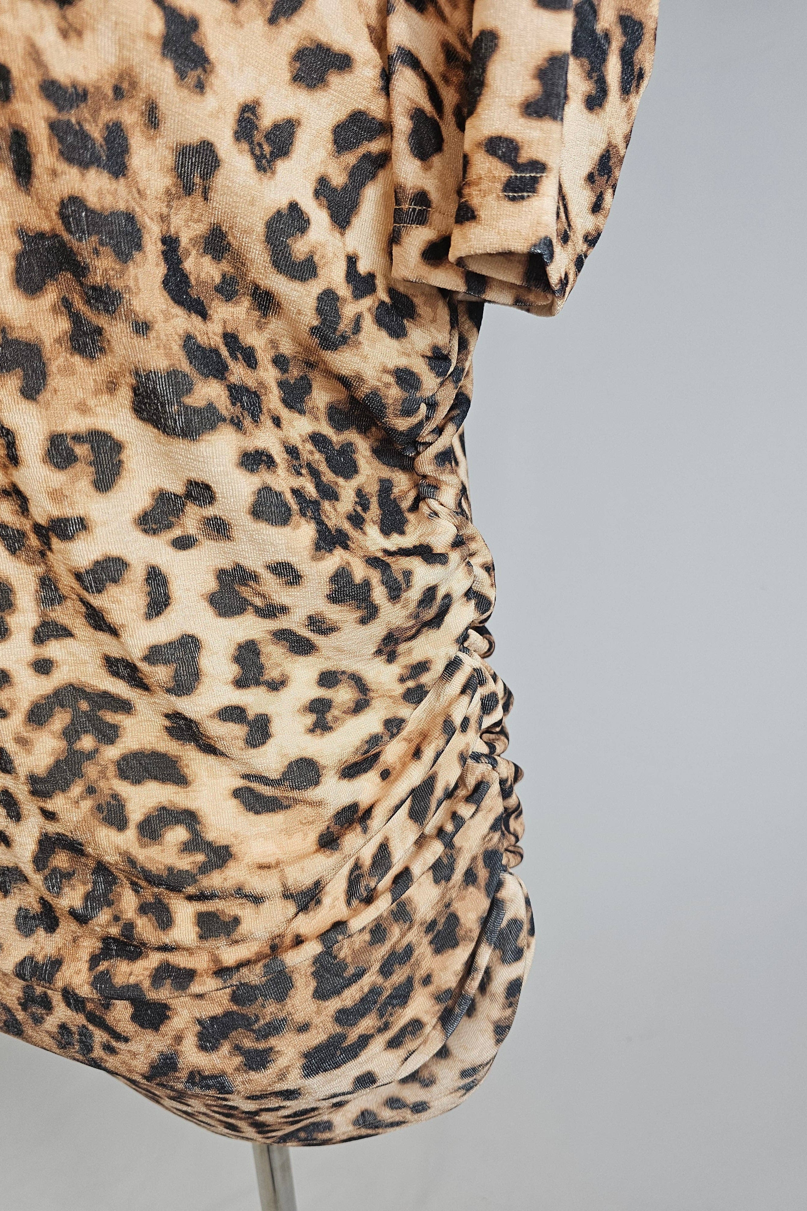 Leopard print dress on a mannequin against a gray background